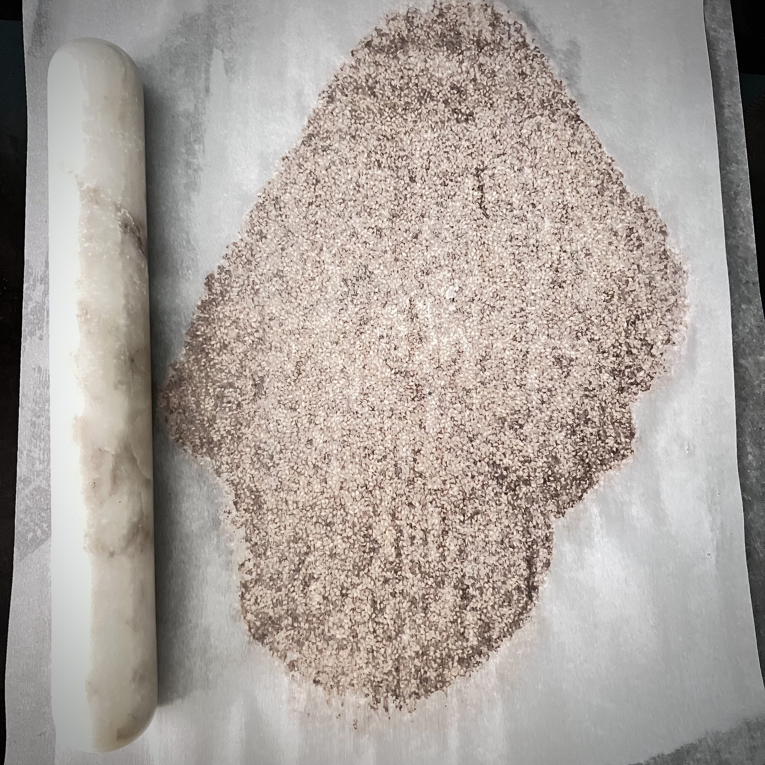 Transfer the hot mixture of sesame of caramel over parchment paper and roll it out into a 1/4 -inch.