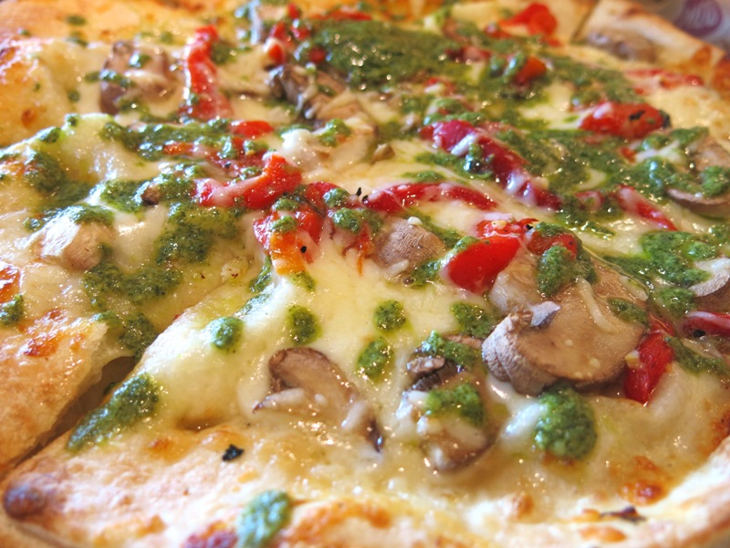 Close-up of Tristan pizza with melted cheese and fresh toppings