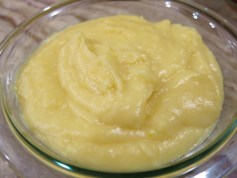 Pastry cream being piped into an éclair shell.