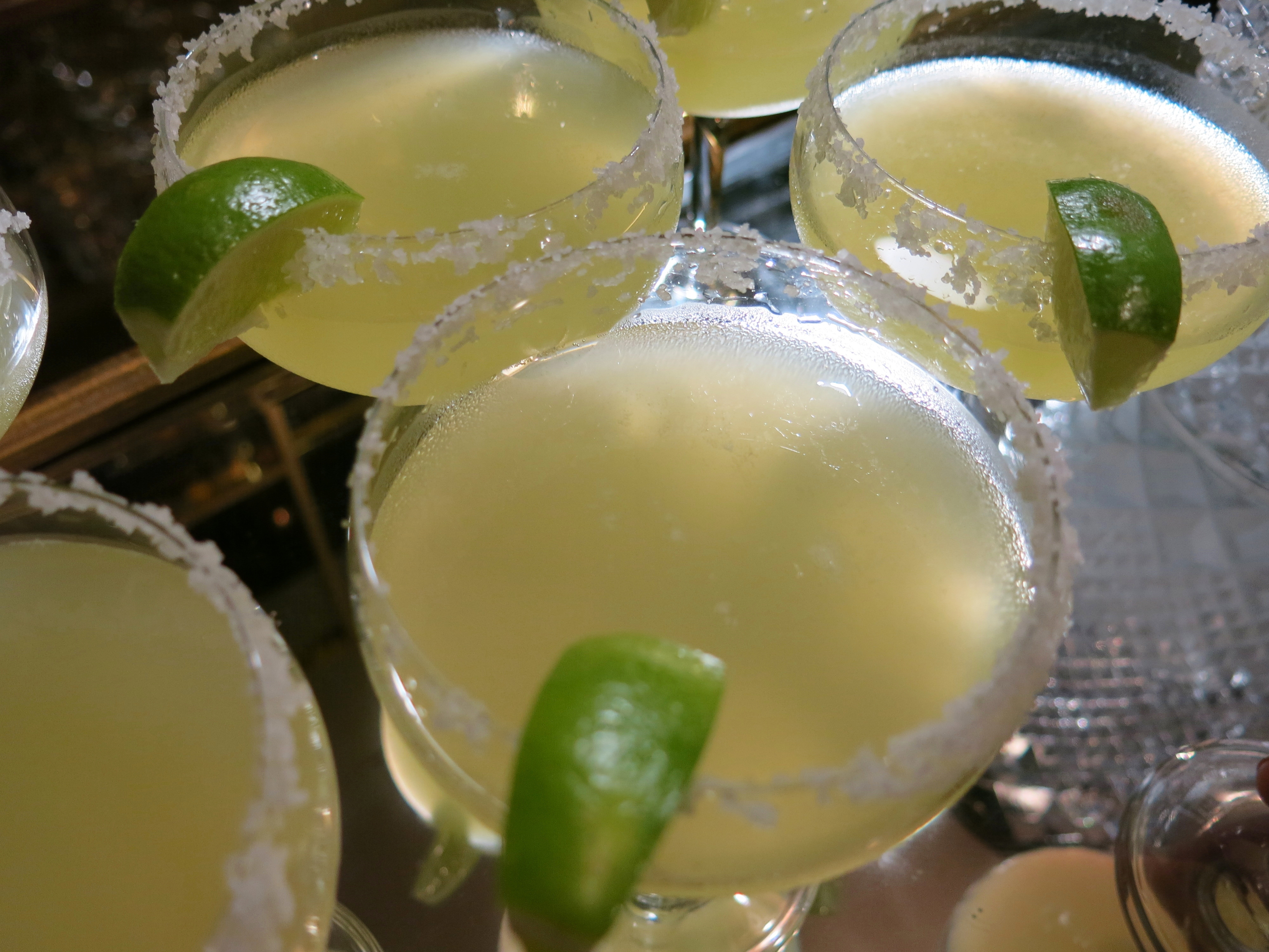 Glasses of salt-rimmed margaritas awaiting guests.