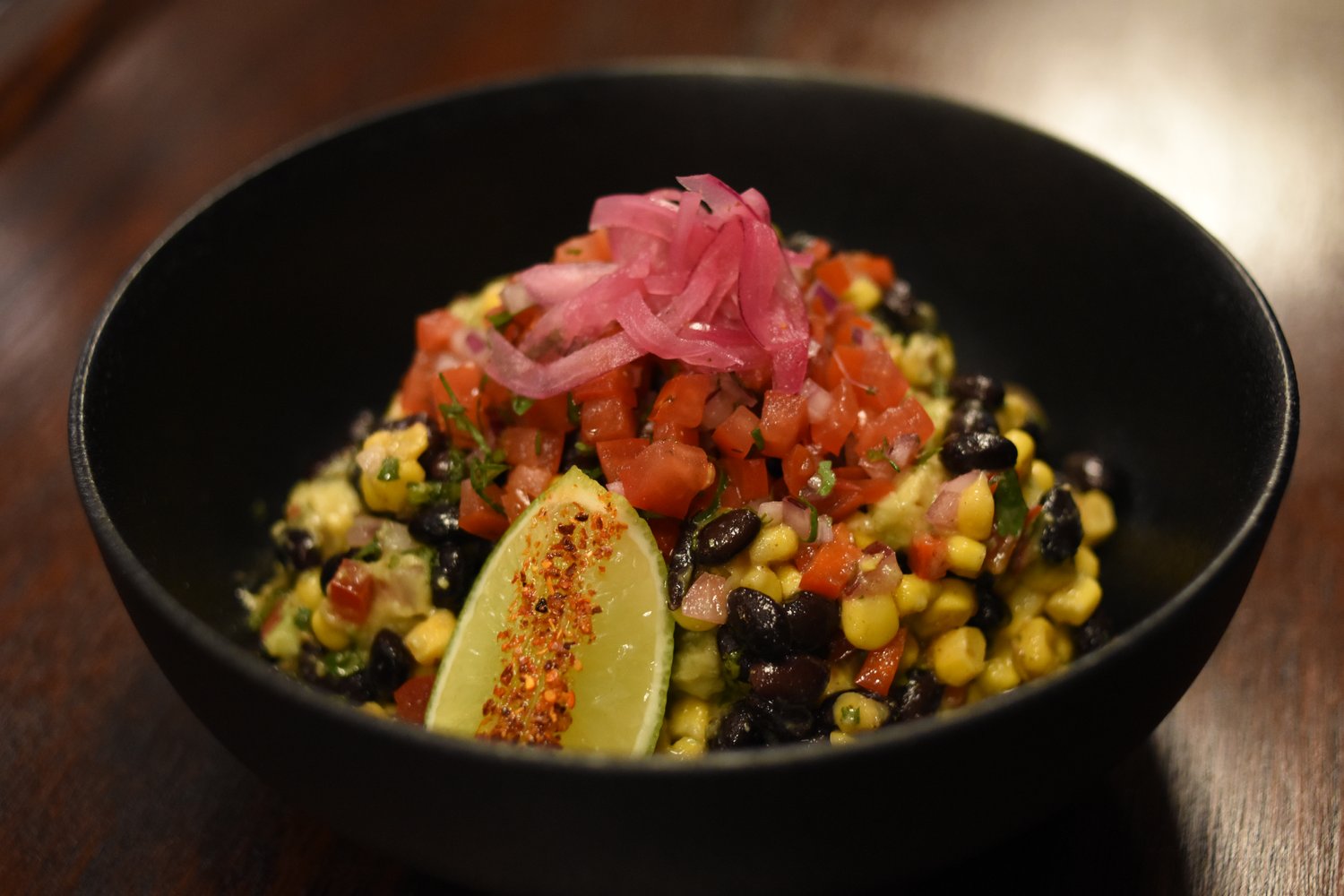 Mexican salad with corn, beans, salsa and lime at Mexican Restaurant