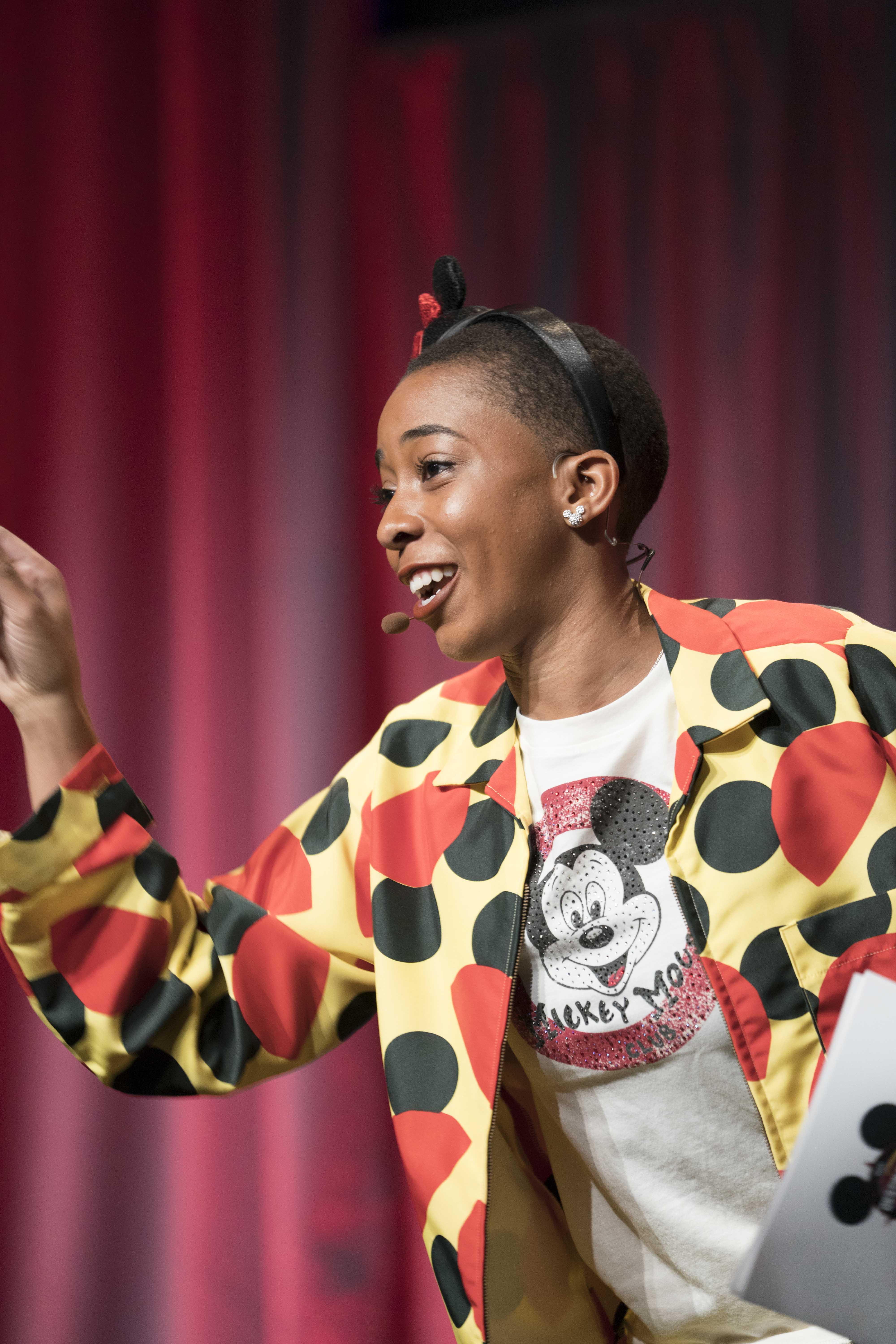 Veronica-Host.jpg: Veronica, the host of Destination D: Celebrating Mickey Mouse, introduces a Mickey Mouse Club Moment in style. As seen at D23’s Destination D: Celebrating Mickey Mouse, November 16-18, 2018 at Disney’s Contemporary Resort. © Disney