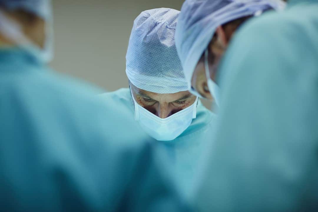 Surgeons working on patient