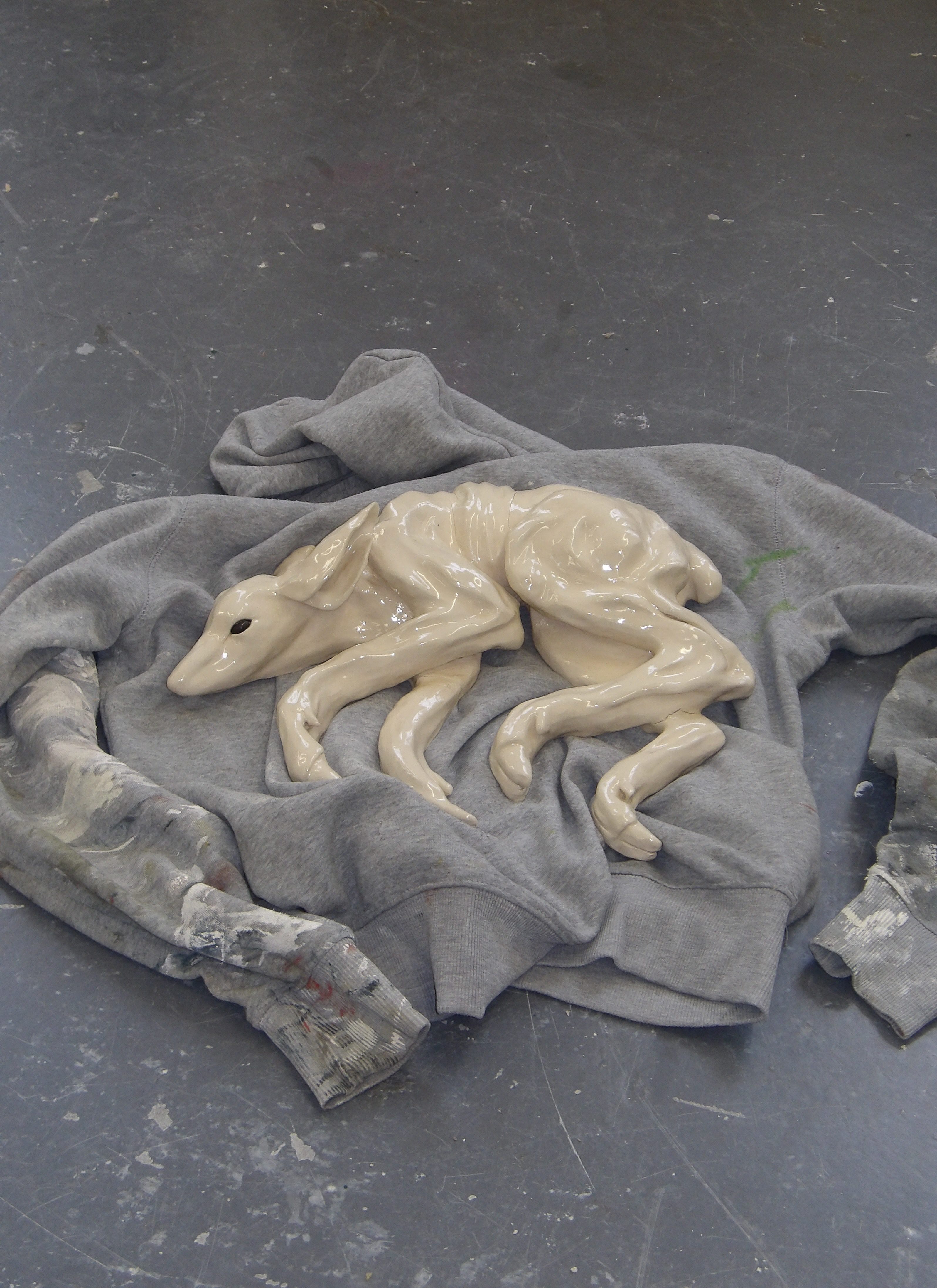 Ceramic deer sculpture lying on a jumper
