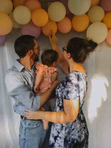 Our family under the handmade birthday balloon garland.