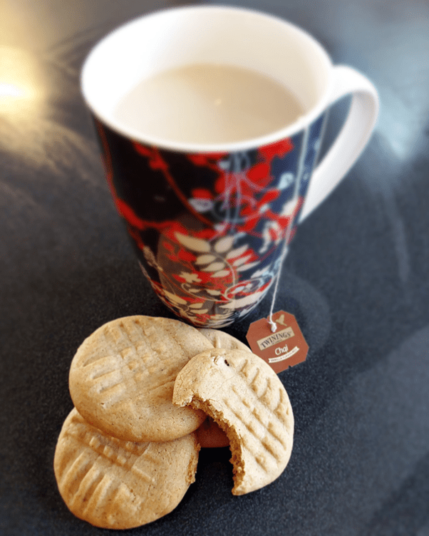 A cup of tea with some spiced biscuits