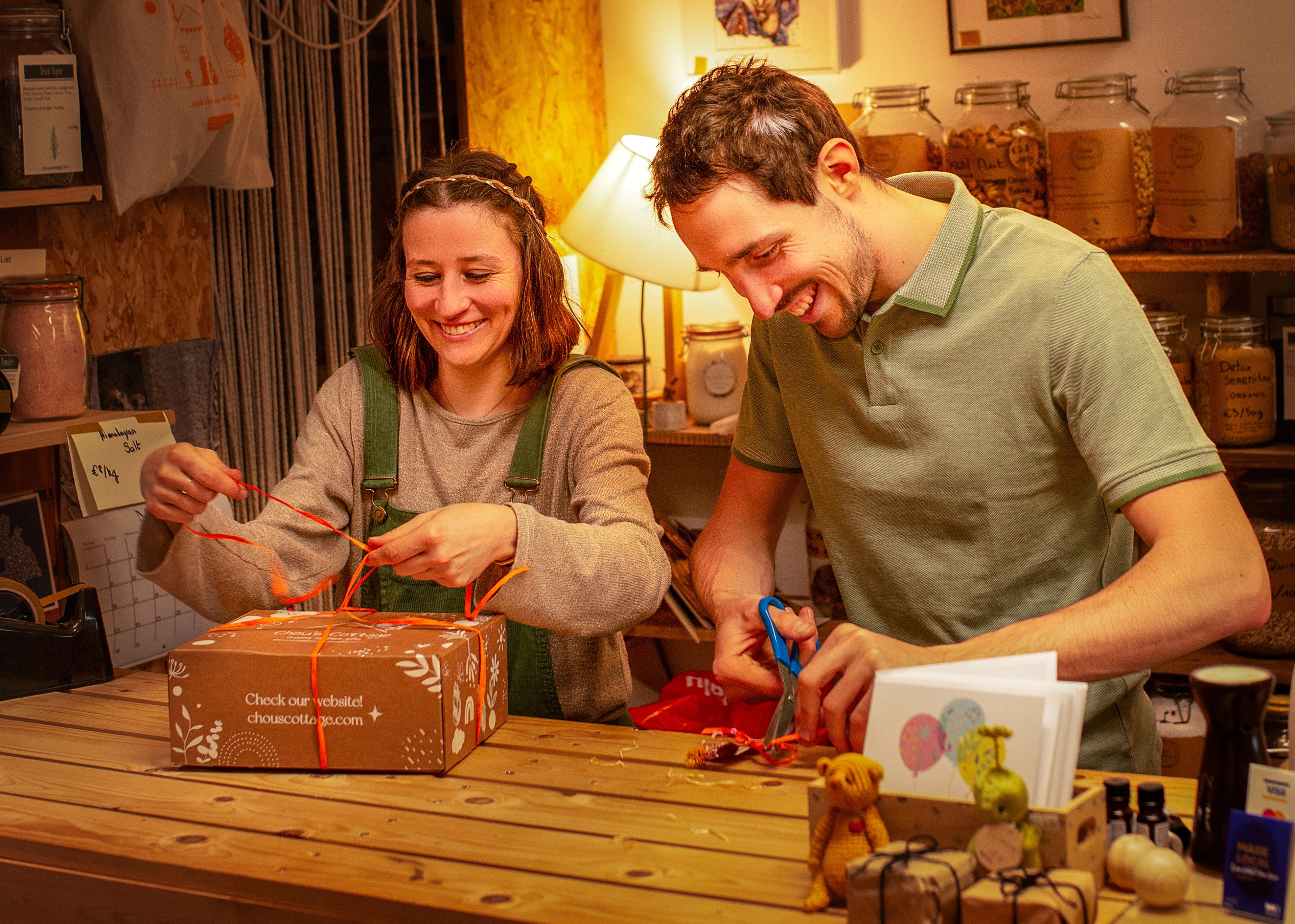 Julie and Paul wrapping a gift box