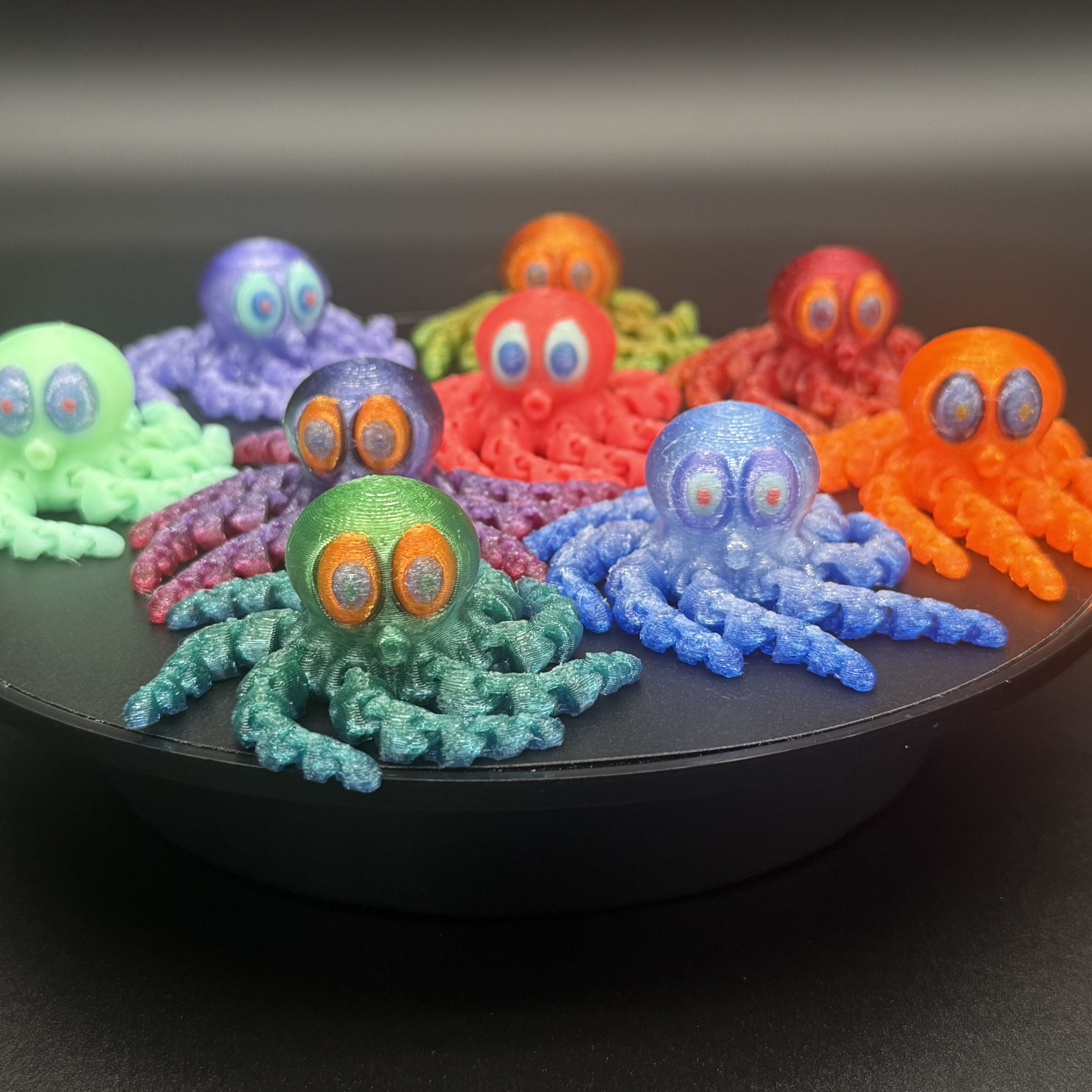 Colorful group of articulated 3D-printed flexi octopus toys