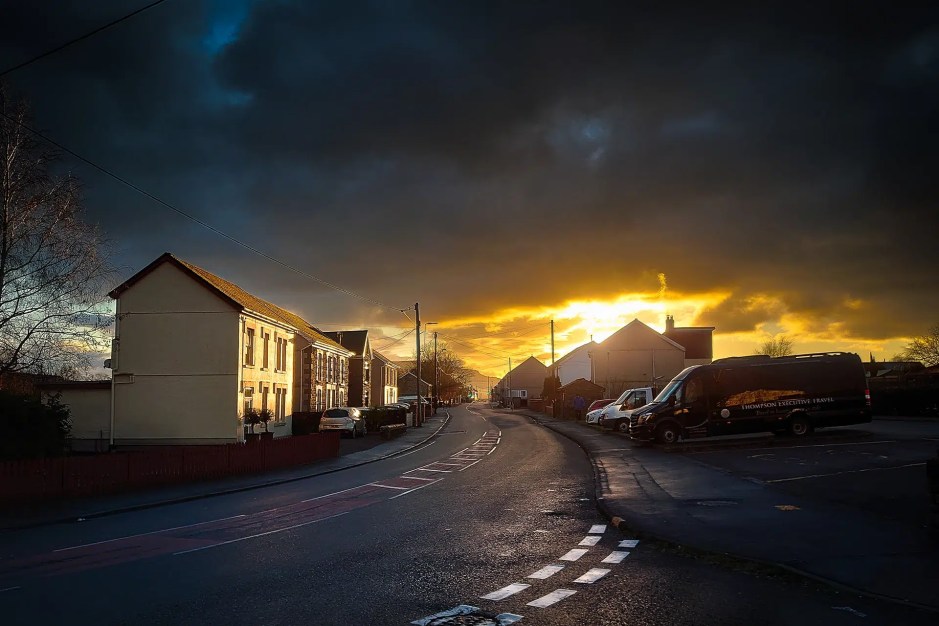 The sun sets over houses in Ystradgynlais