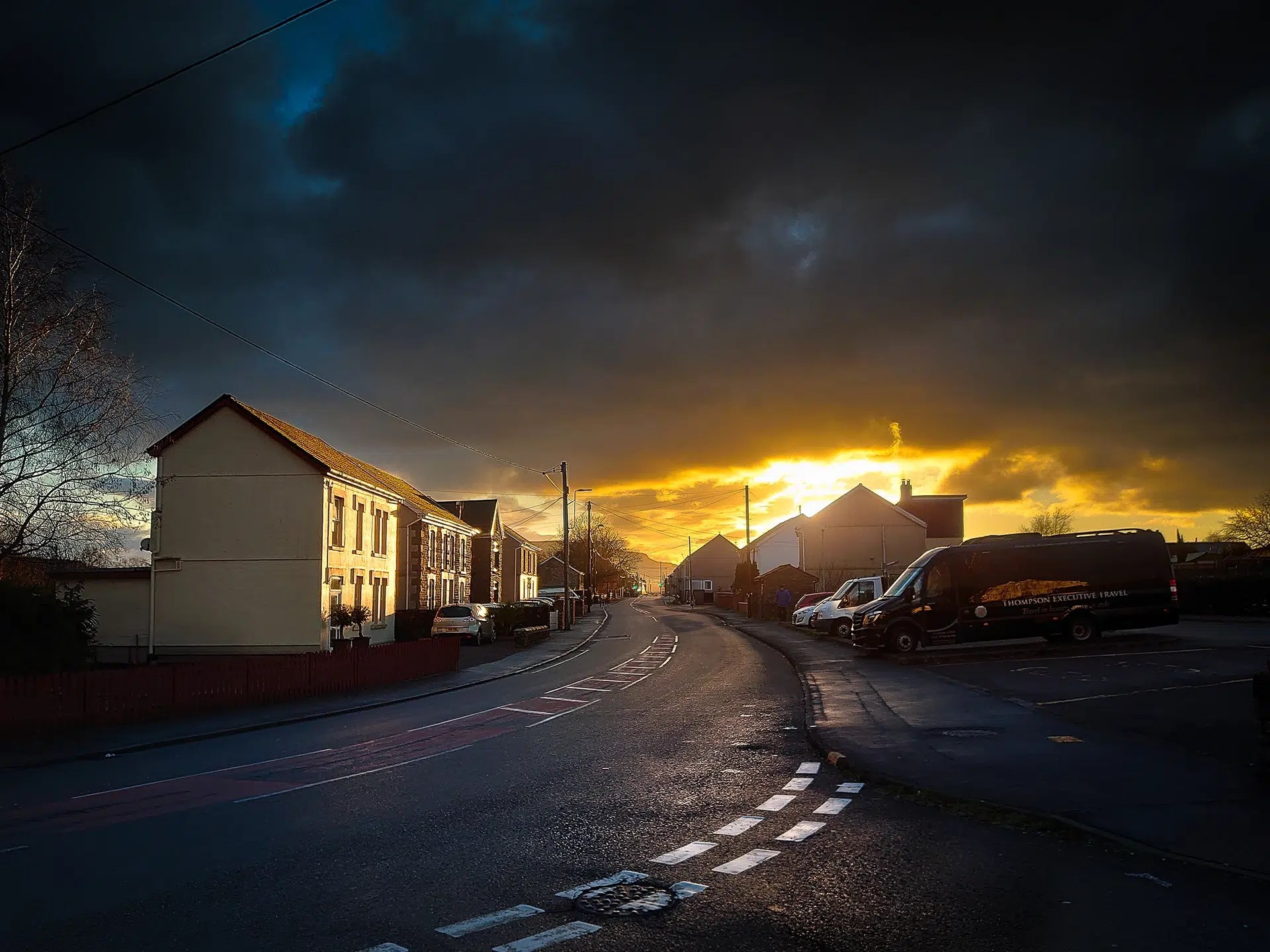 The sun sets over houses in Ystradgynlais