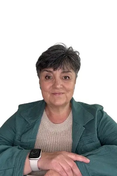 Relaxed headshot of a woman with short dark hair and a soft smile, wearing a green jacket and smartwatch.