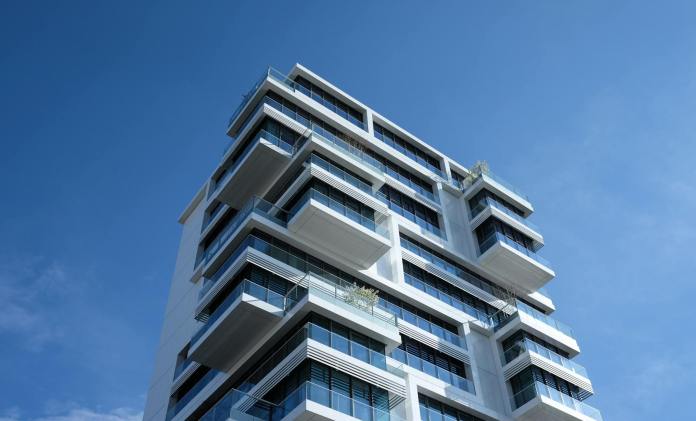 white concrete building under sunny blue sky