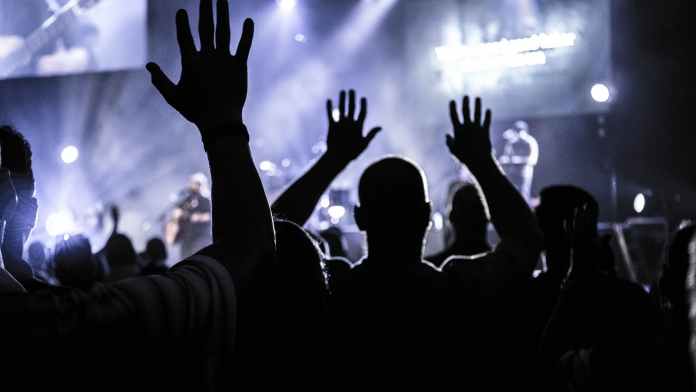 group of people raising hands silhouette photography