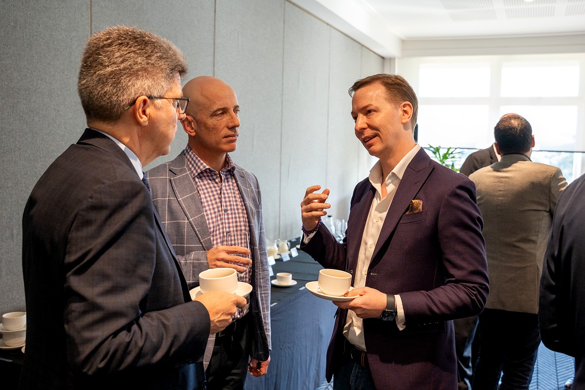 Christopher Warren speaking with industry leaders at a networking session