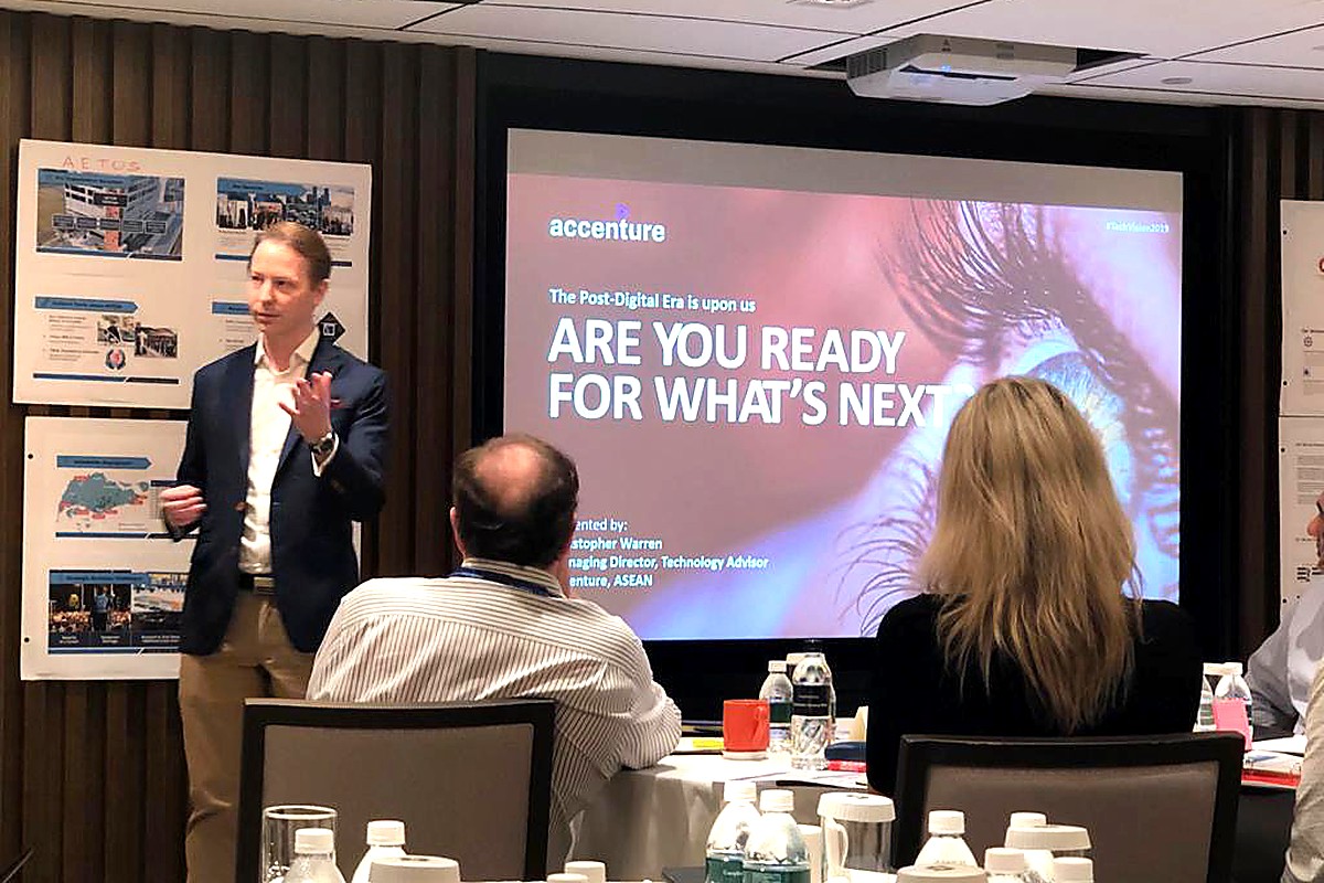 Christopher Warren presenting an executive technology briefing to a boardroom audience