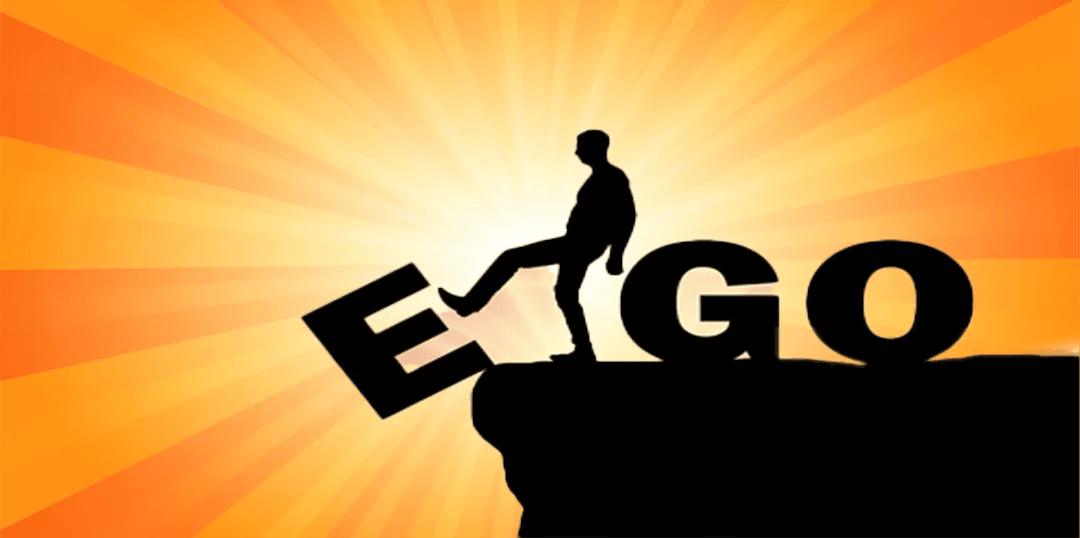 A guy kicking the "e" of ego off a cliff leaving just "go."