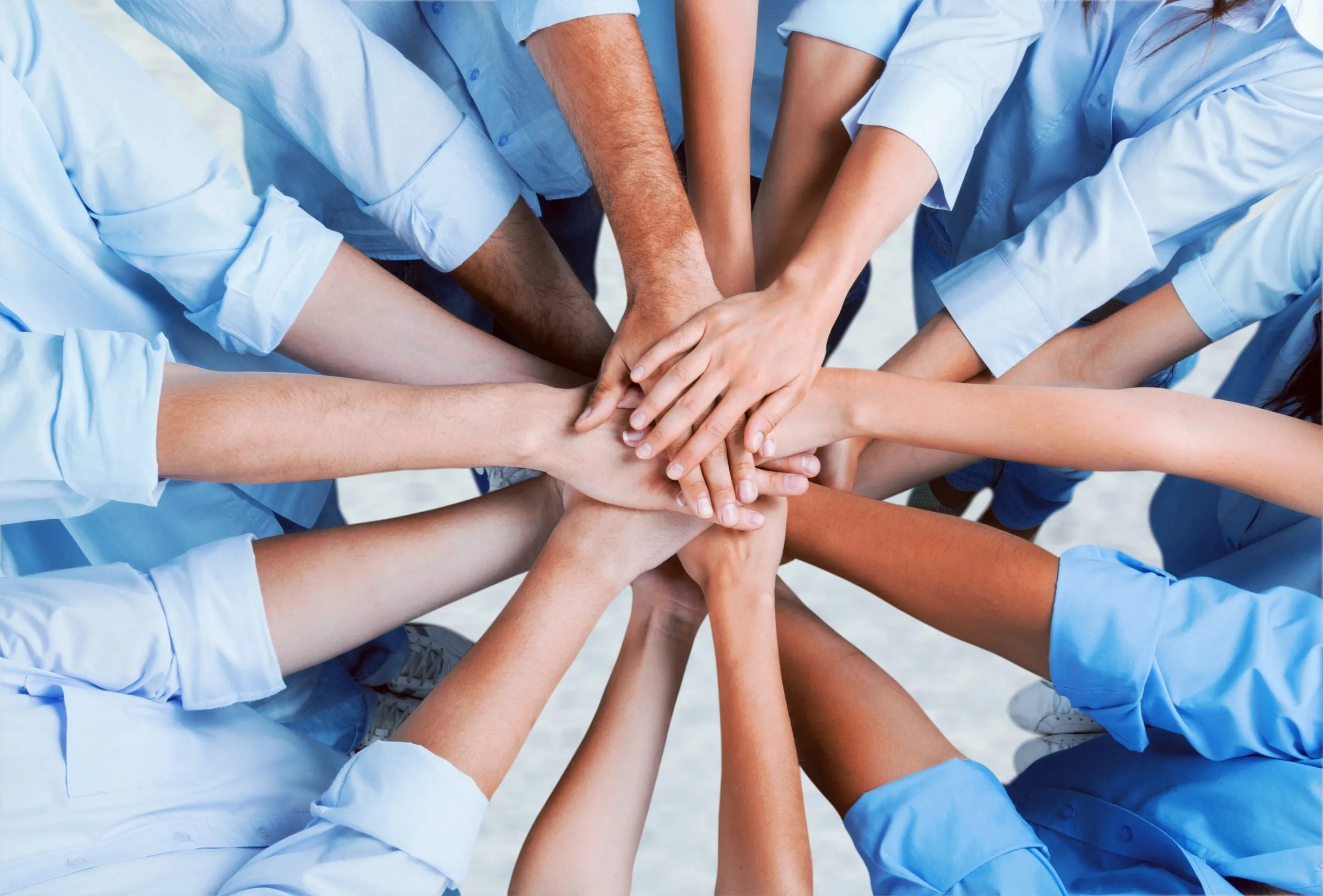 The overlapping hands of people supporting each other