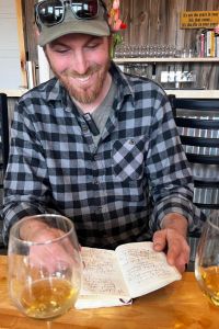 1000 Stone Farm cider maker Kyle Doda with record book