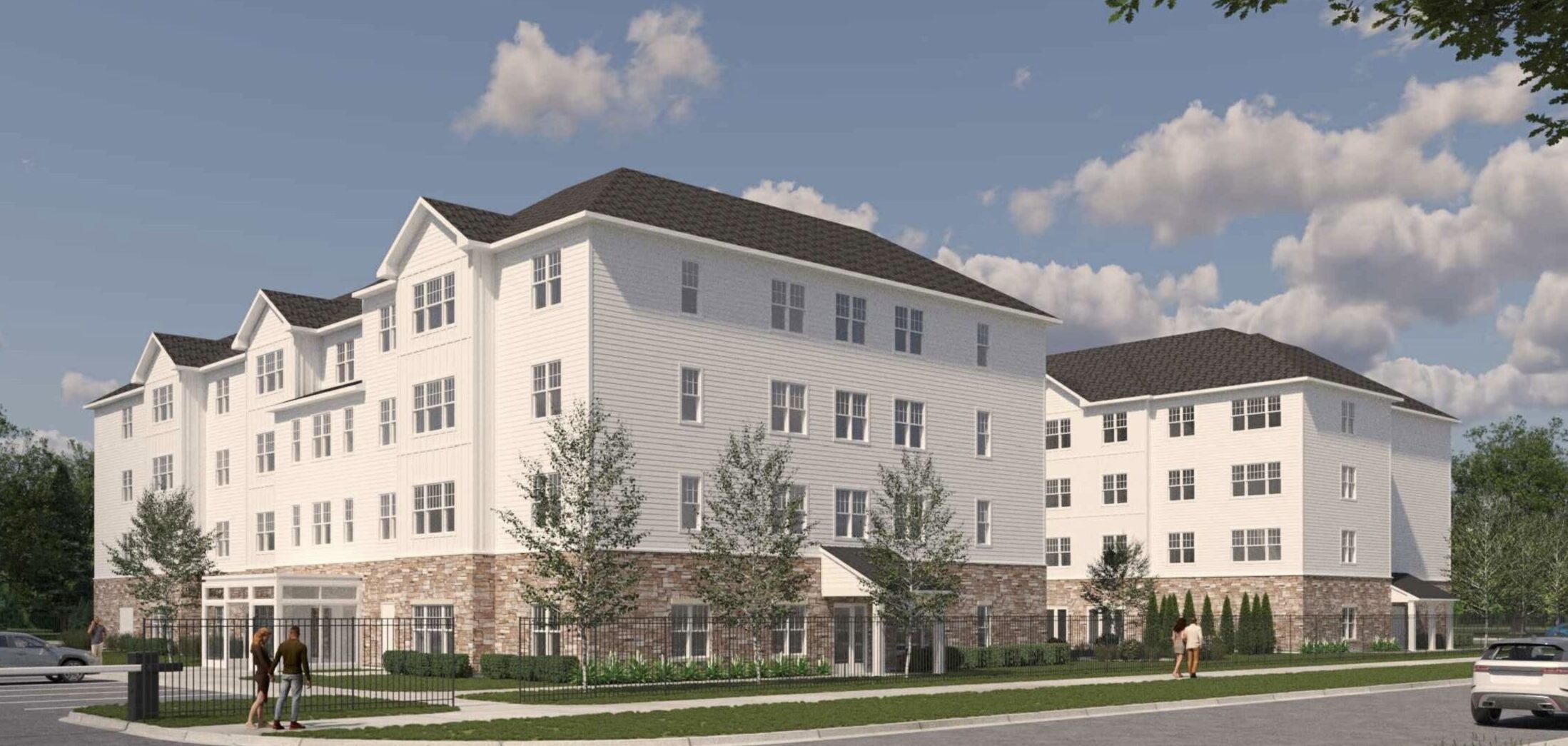 4 story apartment building with trees around it