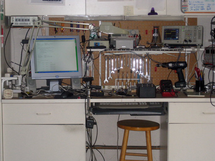 Instruments in Jerry's lab include a waveform generator, a digital storage oscilloscope, a digital multimeter, a couple of power supplies, and a soldering station.