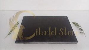 A CNC machine precisely cutting a block of basalt