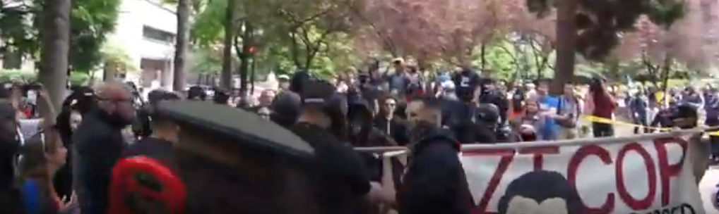 Tiny starts pushing the person back, into a banner. Joey still in tow.