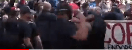 Tiny throws a right-hook, throwing the first punch of the day.