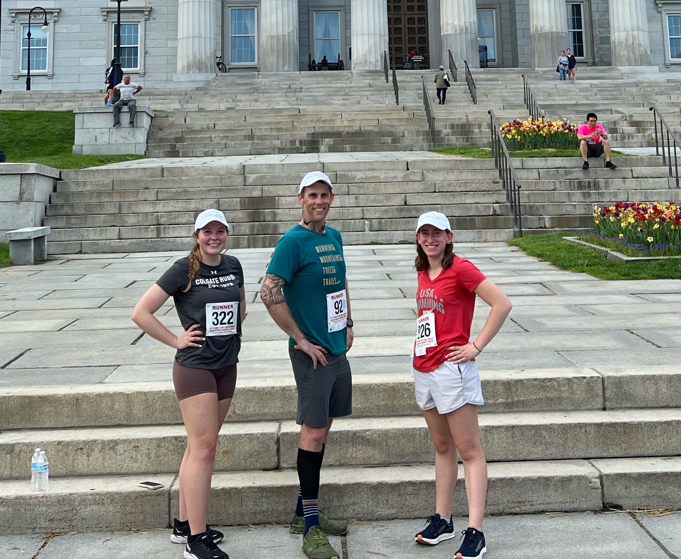 TCG employees and friend standing in front of the Montpelier State House preparing for a community race. Left to right, Lauren Divonas and Patrick Blanchard and non-employee friend.