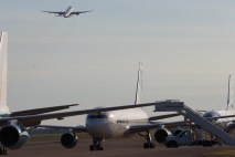 220627-A-WL623-415 A Boeing 777-200ER carrying elements of 2nd Brigade Combat Team, and 101st Headquarters and Headquarters Battalion, 101st Airborne Division, departs for Europe June 27 from Campbell Army Airfield, Fort Campbell, flying over a series of aircraft preparing to transport additional soldiers. (Ethan Steinquest, Fort Campbell Public Affairs Office)