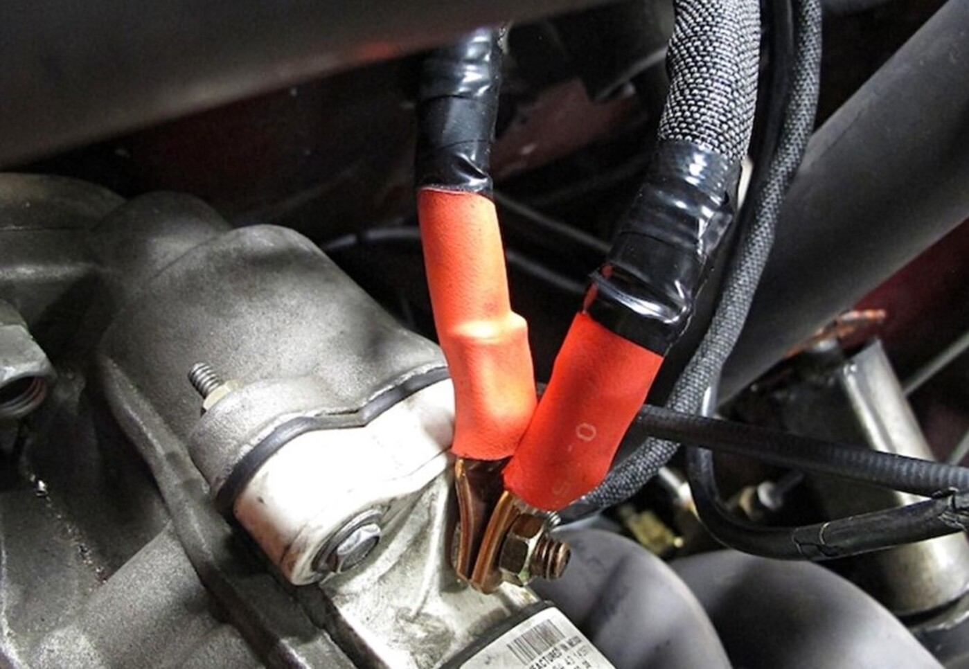 Positive battery wires connected to the engine starter as part of the battery relocation