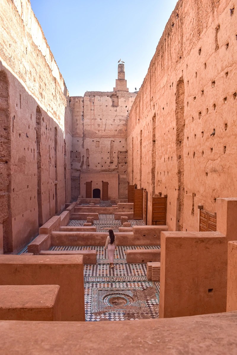 A girl in a white outfit exploring the ruins at Badi Palace in Marrakech