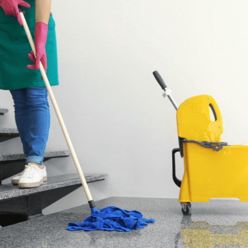 commercial cleaning services - a cleaner mopping communal stairs