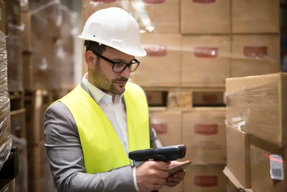 Warehouse technician scanning inventory with a handheld barcode reader
