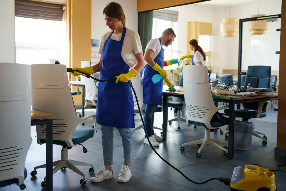 Commercial cleaning crew servicing an open-plan office