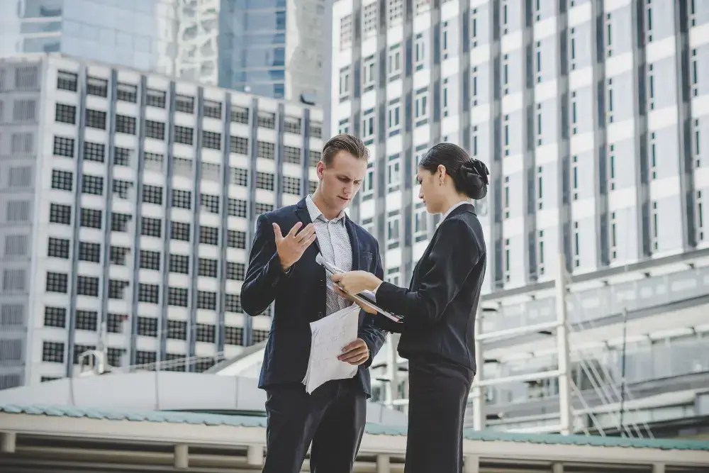 Facility manager and commercial service provider meeting outside an office building