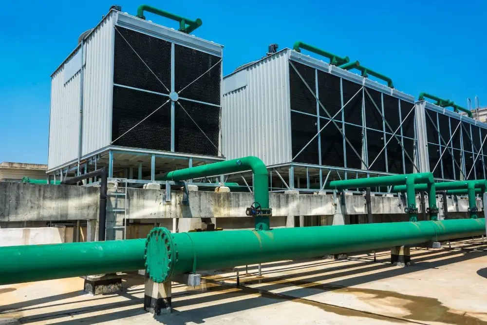Rooftop commercial HVAC chiller units and piping on a building