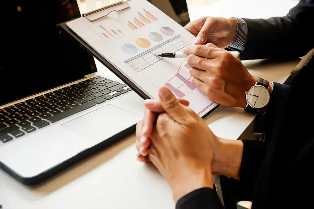 people reviewing reports printed out