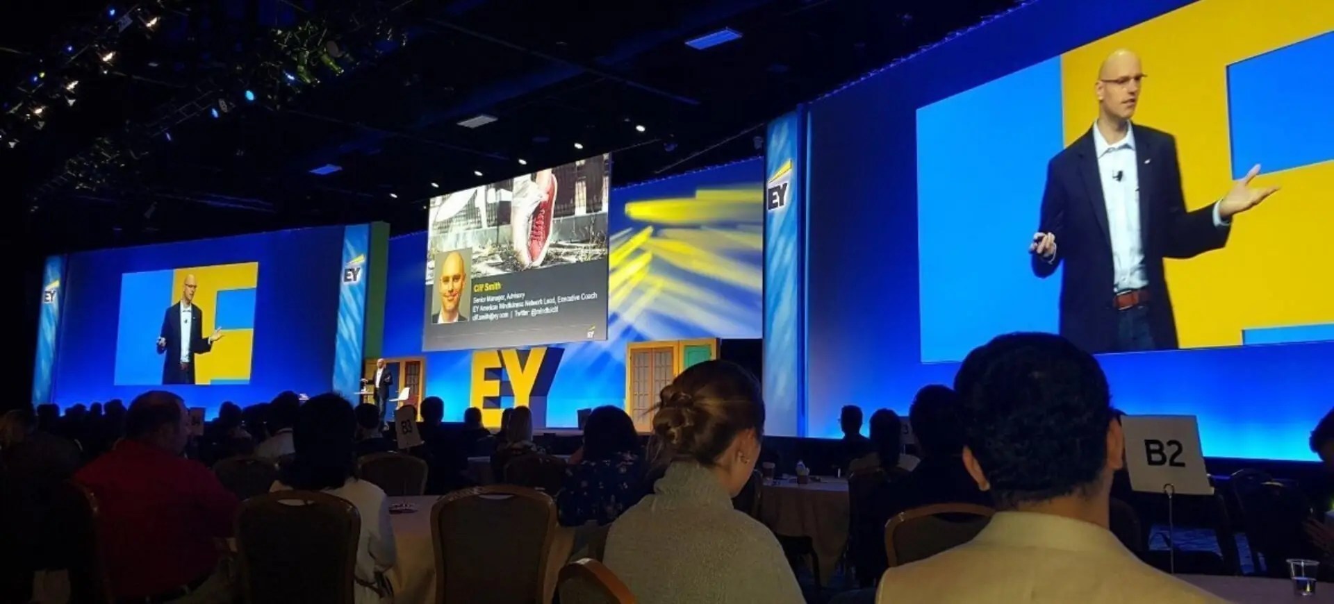 Clif Smith delivering a keynote to a large audience