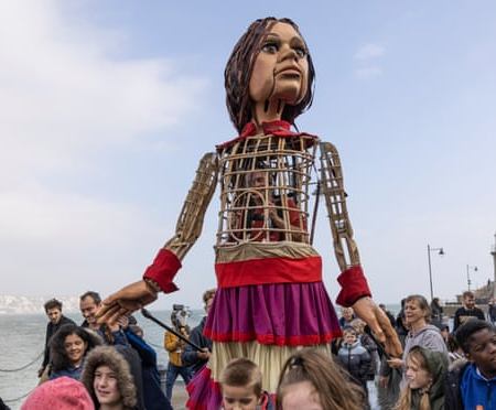 Little Amal walks along Folkestone pier. Photograph: Dan Kitwood/Getty Images