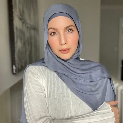 A woman comfortably wearing a modal hijab, highlighting the fabric's fluid drape. Clothifydotpk