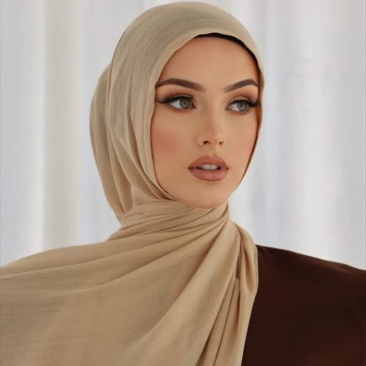 A woman comfortably wearing a modal hijab, highlighting the fabric's fluid drape. Clothifydotpk
