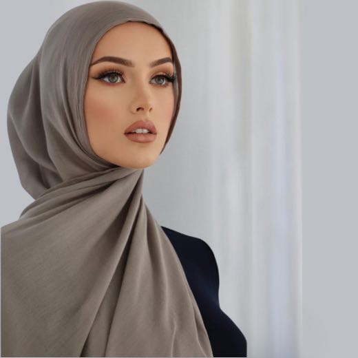 A woman comfortably wearing a modal hijab, highlighting the fabric's fluid drape. Clothifydotpk
