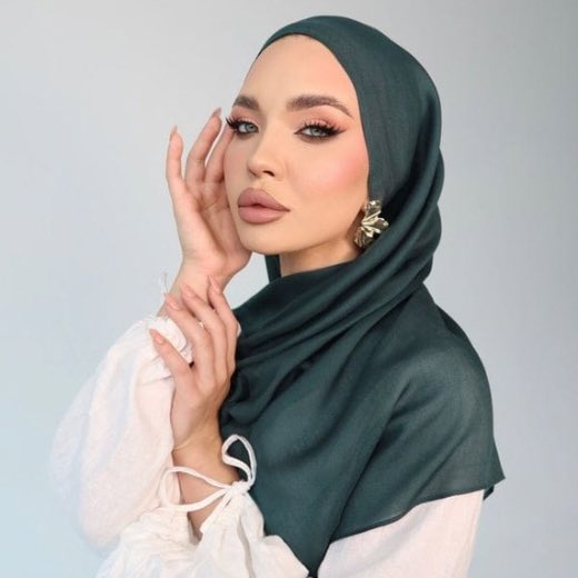 A woman comfortably wearing a modal hijab, highlighting the fabric's fluid drape. Clothifydotpk