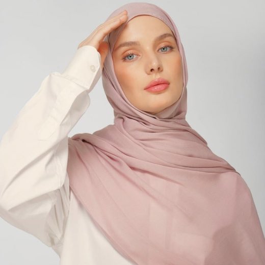 A woman comfortably wearing a modal hijab, highlighting the fabric's fluid drape. Clothifydotpk