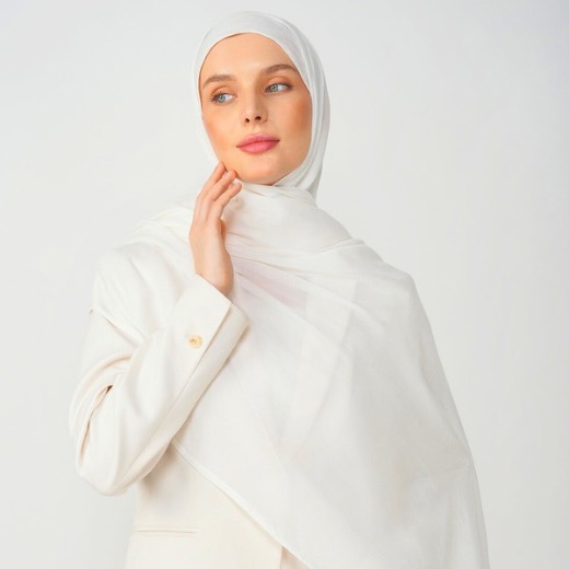 A woman comfortably wearing a modal hijab, highlighting the fabric's fluid drape. Clothifydotpk
