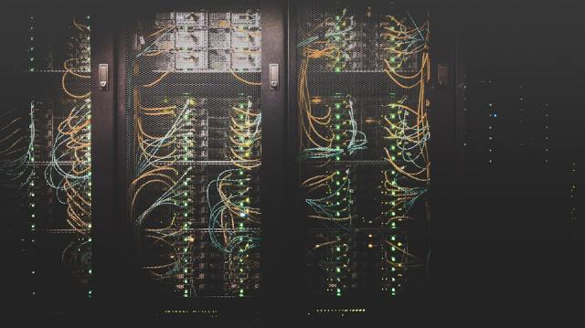 Server room network cables representing IT infrastructure that requires ongoing patch management