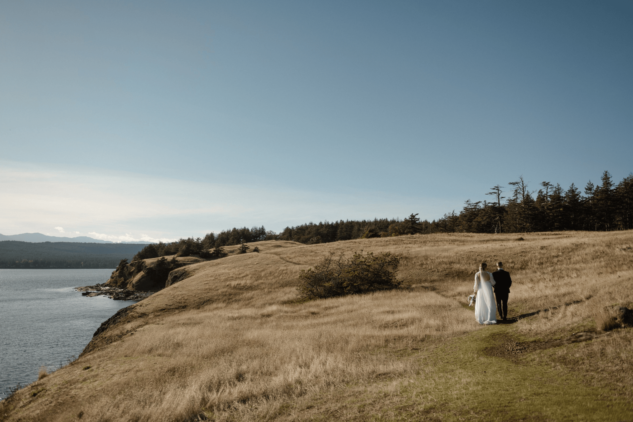 Newly weds walk along the beautiful cliffs at Helliwell park on Hornby Island