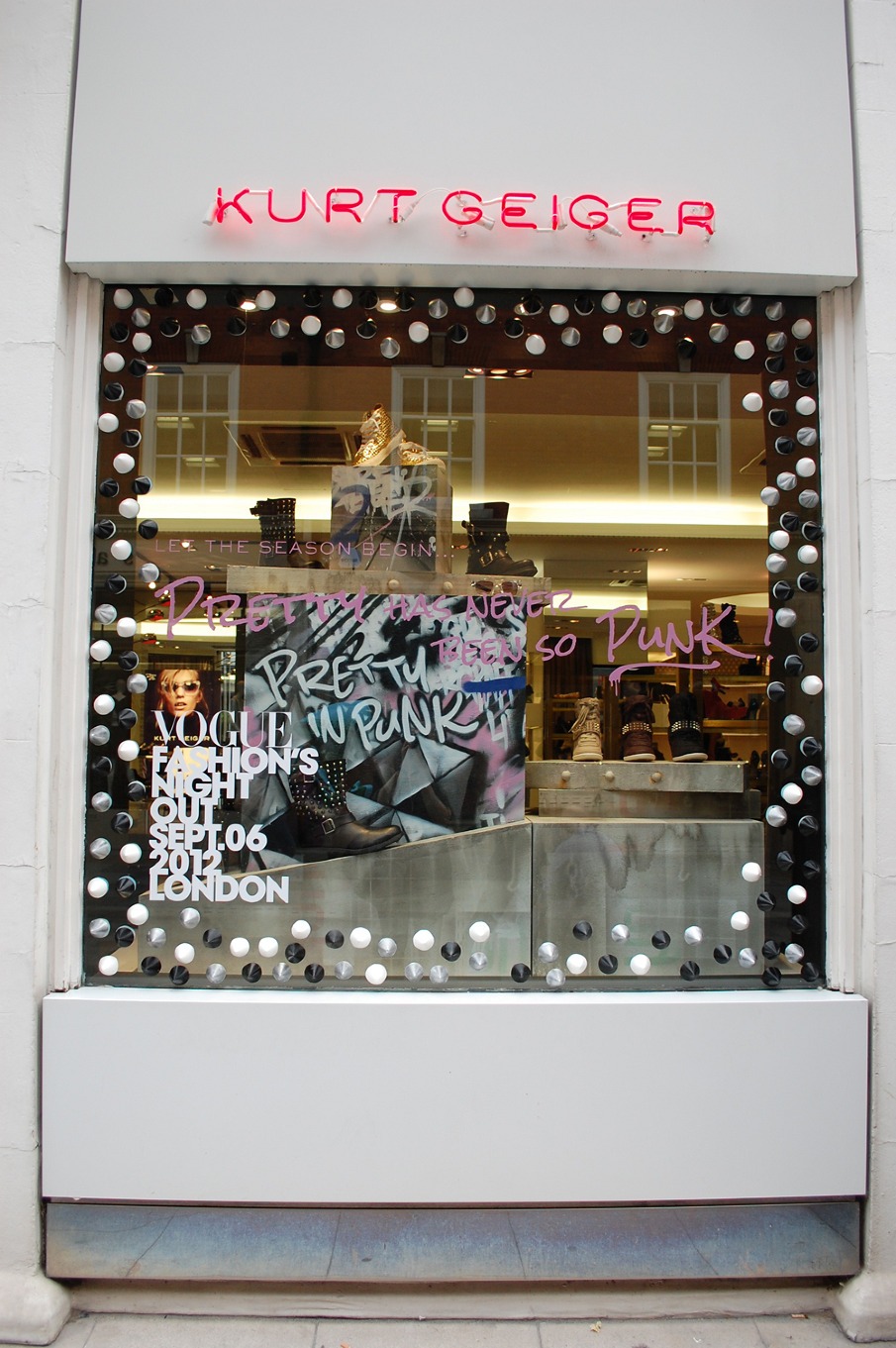 Escaparate de Kurt Geiger con el mensaje «Pretty in Punk» y botas sobre peanas metálicas