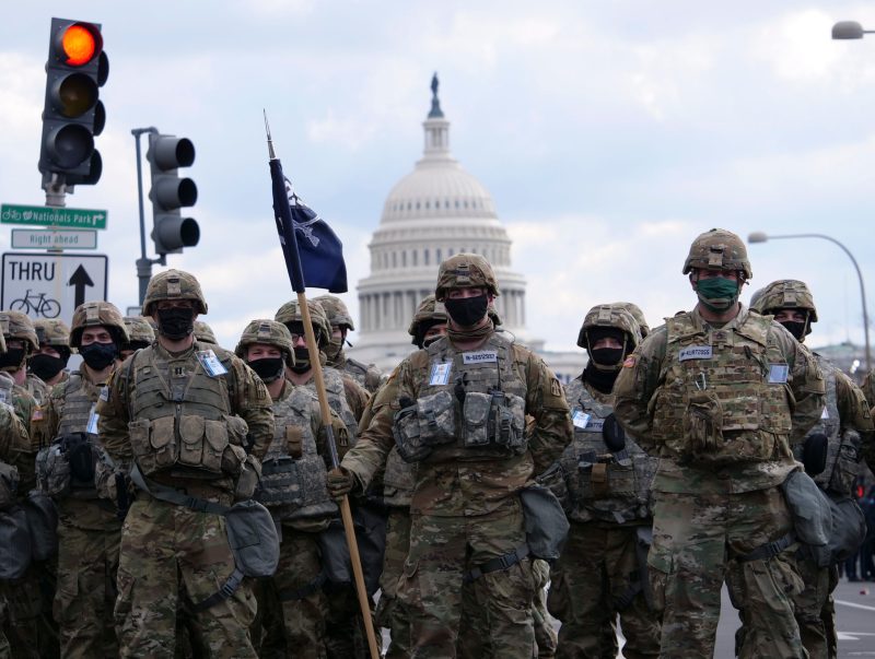U.S. Soldiers with the Indiana National Guard National Guard stand in formation, in Washington, D.C., Jan. 20, 2021. At least 25,000 National Guard men and women have been authorized to conduct security, communication and logistical missions in support of federal and District authorities leading up and through the 59th Presidential Inauguration. (U.S. Army National Guard photo by Sgt. Tackora Hand)