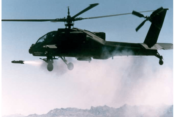 An AH-64 Apache unleashes a Hellfire missile with pinpoint accuracy, demonstrating its lethal versatility in countering certain airborne threats on the modern battlefield.